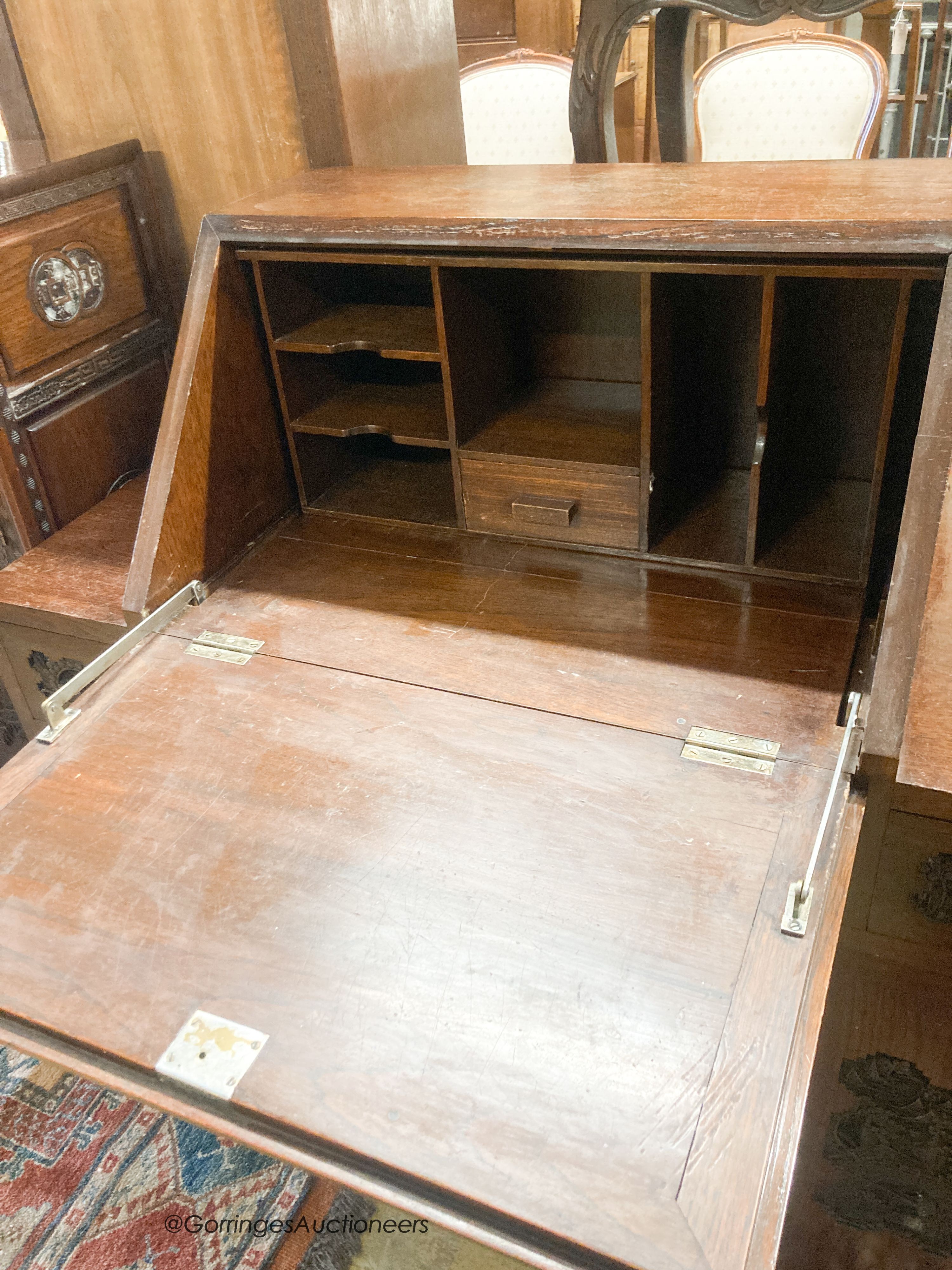 A 20th century Chinese carved hardwood bureau fitted with three drawers, width 107cm, depth 45cm, height 108cm and a cupboard